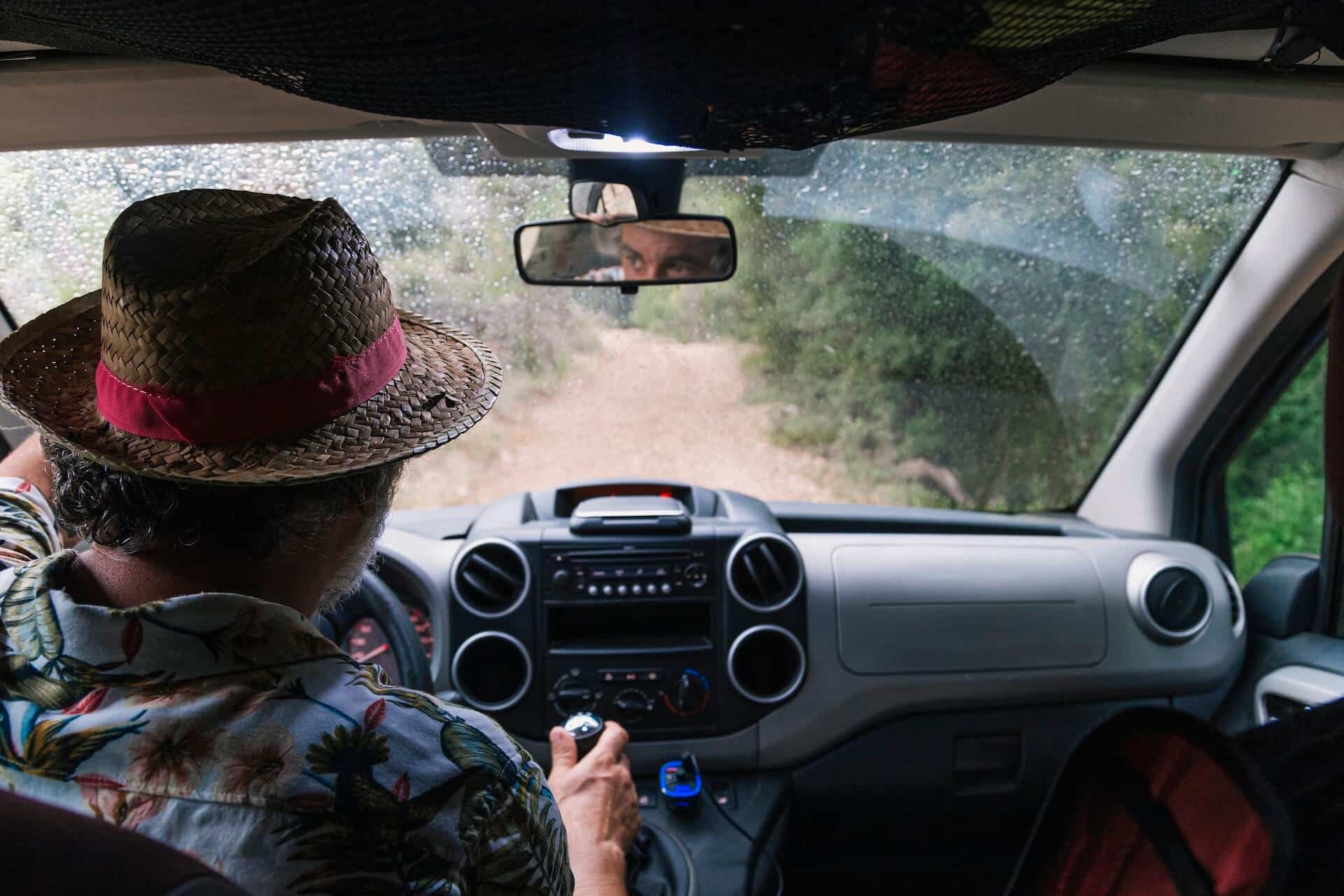 basics-of-off-roading-01 Man in a wicker hat driving down a dirt road | image for the Basics of Off Roading: How to Get Started blog.